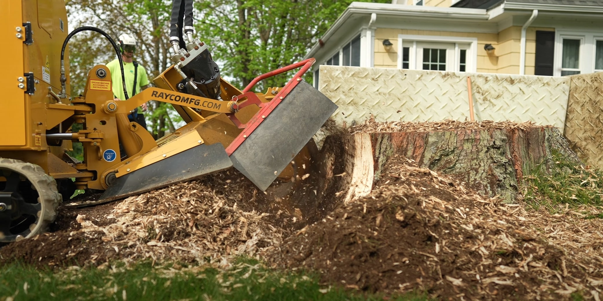 Stump grinding machine removing tree stumps in Greenacres, FL